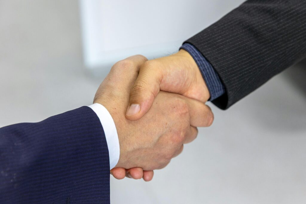 Close-up of two people shaking hands.
