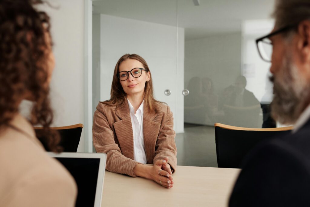 Woman seated at a table listening attentively